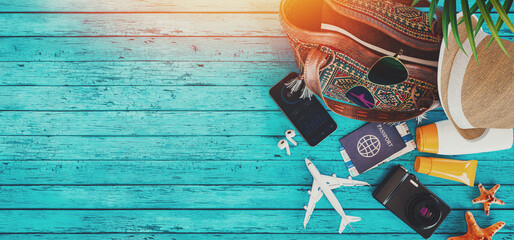 Summer Travel Accessories on Blue Wooden Texture