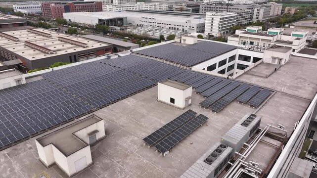 Aerial view of distributed photovoltaic arrays installed on urban building rooftops