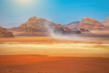 Wind and dust in red desert. Martian landscape. Wadi rum desert