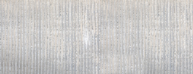 Concrete wall featuring rough vertical striped texture