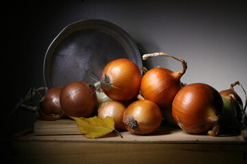 Vegetables. Onions lying on a wooden surface.