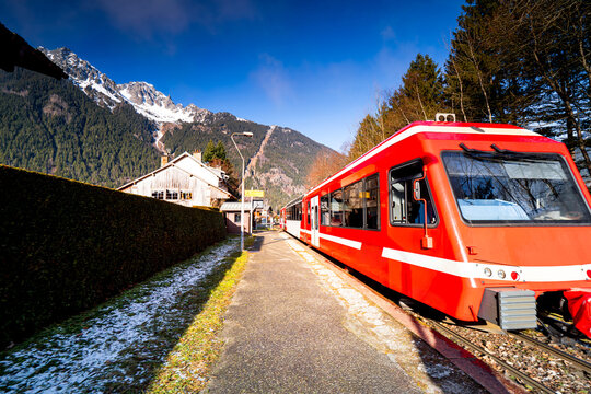 Red train at Les Praz de Chamonix station. French Railway in the Alps. Mode of transport in Chamonix Mont Blanc.
