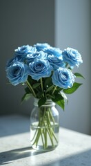 Vase with blue roses in it on a table
