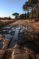 sunset on ancient roman road of appian way	