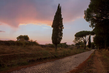 sunset on ancient roman road of appian way	