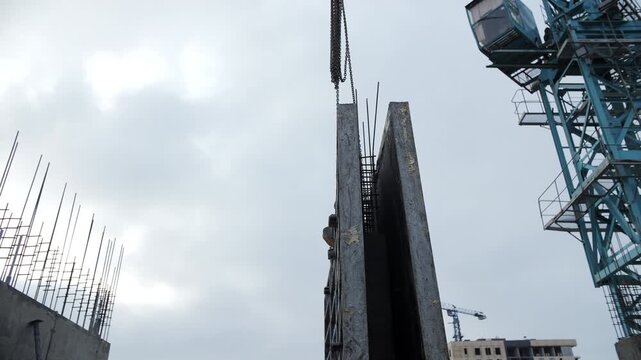Tower crane lifting vertical concrete formwork panel