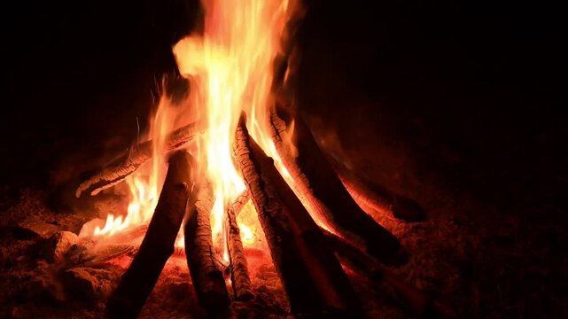 A mesmerizing image of fire flames in the dark. The fiery dance of the flames casts an inviting and warm glow in the night. The photo showcases the beauty and energy of nature's elements. Stock Video