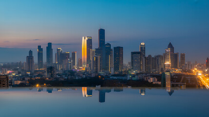 Fototapeta premium Spectacular Bangkok Skyline at Dusk with City Lights Reflecting in Water, Thailand Urban Landscape, Modern Architecture, Travel Destination