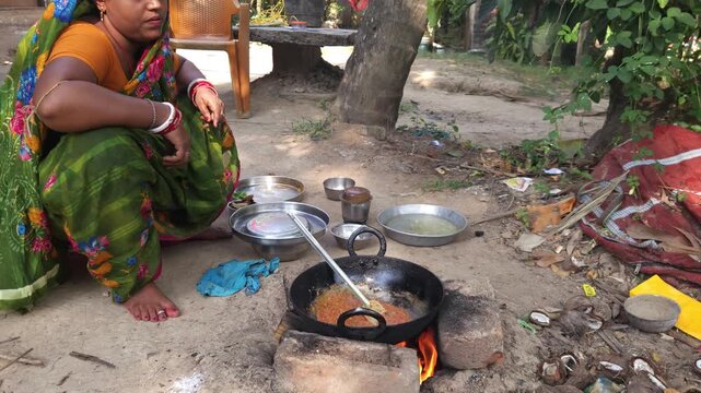 Rural Indian Woman Cooking Outdoors in Traditional Village Kitchen, Preparing Food on Wood Fire Chulha, Authentic Indian Lifestyle, Culture and Rural Life