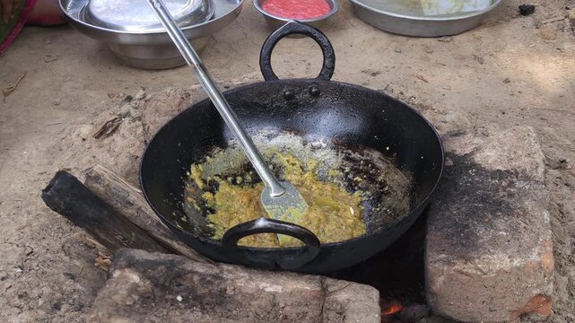 Rural Indian Woman Cooking Outdoors in Traditional Village Kitchen, Preparing Food on Wood Fire Chulha, Authentic Indian Lifestyle, Culture and Rural Life