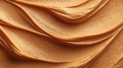 Creamy peanut butter texture in warm golden tones forms a smooth, appetizing background ideal for sweets branding, bakery advertising, food design, and dessert visuals
