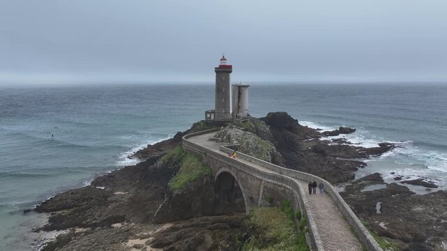 Aerial view of the Petit Minou Lighthouse standing tall on a rocky islet connected by a stone bridge, Bretagne, France.