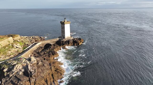 Aerial view of Petit Minou lighthouse standing tall on a rocky outcrop, surrounded by the vast expanse of the sea, Bretagne, France.