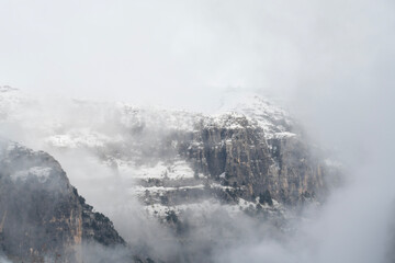 Foggy snow mountains in winter landscape