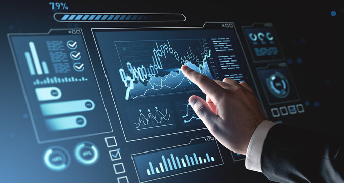 Businessman interacting with futuristic hologram interface displaying financial data and digital charts on a dark blue background. Concept of analytics. - Powered by Adobe