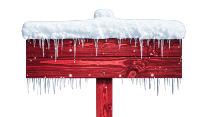 Red wooden signpost covered in snow and ice with icicles against black