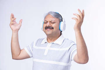 Enjoying the music. Attractive man is smiling while wearing headphones.