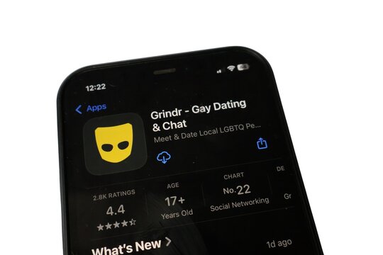 Grindr gay dating and chat app on Apple App Store display, LGBTQ social networking concept, iPhone screen close-up isolated on white background