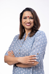 Portrait of confident woman wearing formalwear with arms crossed standing against white background
