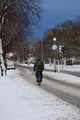 Aberdeen scotland 3rd January 2025 A cyclist riding down the snowy road in a snowy day. Cars in the background