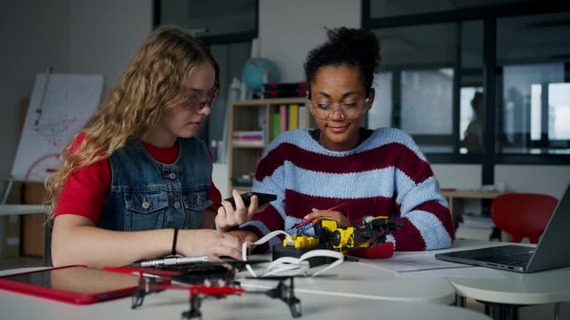 High school students working on robotics project. Girls in STEM.
