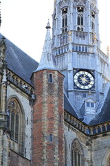 Obraz premium Sint-Bavokerk Church Exterior Detail with Tower and Clock in Haarlem, Netherlands
