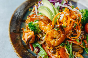 Fresh wok bowl with vegetables nuddles and shrimps