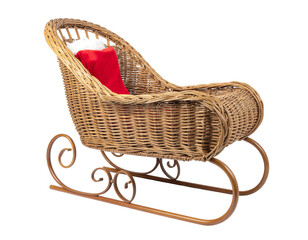 Woven wicker cradle chair with curved metal runners and red cushion for rustic living spaces