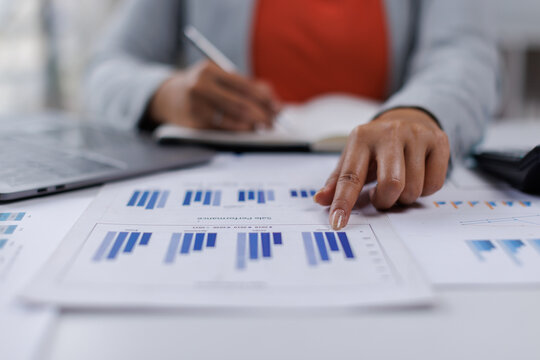 Female Professional Using Calculator for Business Budget Analysis
 - Powered by Adobe