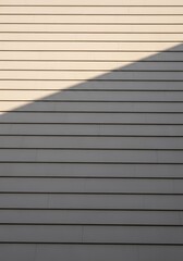 Obraz premium Sunlight plays across the exterior paneling, creating a geometric pattern