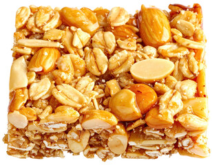 Close-up of a square snack bar with mixed nuts, oats, and a caramelized glaze