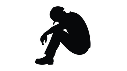 Silhouette of a defeated worker or laborer sitting alone in despair and deep exhaustion