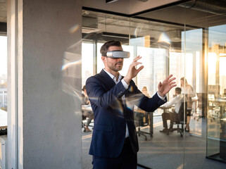 Professional man in virtual reality glasses working in office technology future digital interface innovation business background copy space simulation cyber