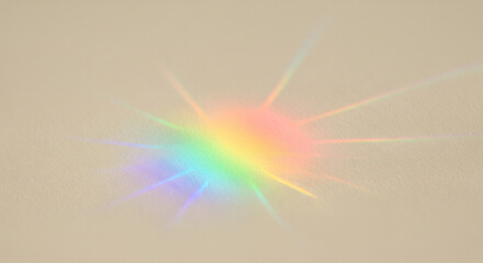 A vibrant rainbow prism flare and spectral light rays on a neutral light background. The optical refraction creates a soft, dreamy, and ethereal glow