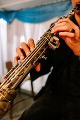 Musician's Hands Skillfully Playing a Soprano Saxophone