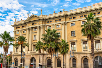 Facades of classic buildings on Barcelona's waterfront on a day with clouds and clearings, Spain.