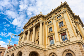 Facades of classic buildings on Barcelona's waterfront on a day with clouds and clearings, Spain.