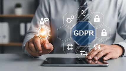 Businessman interacting with a virtual screen displaying GDPR concept and data protection icons.