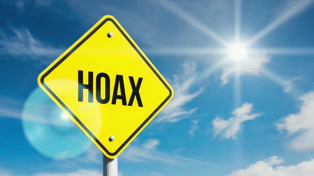 Yellow Warning Sign with Hoax Text Under Bright Blue Sky
