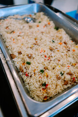 Delicious Fried Rice with Vegetables and Meat in Catering Tray