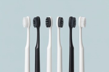 Six toothbrushes white and black arranged in a row on light blue background hygiene