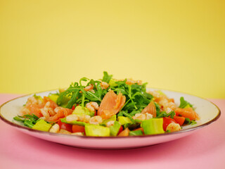 Side view salmon shrimp avocado arugula salad arranged for a healthy step by step recipe showing balanced ingredient composition. pro photo