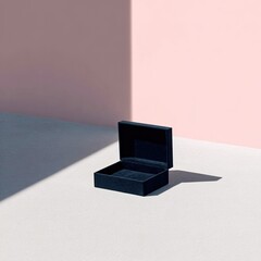 Open navy box casts sharp shadows on pink and grey backdrop