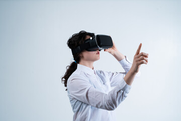 Woman using virtual reality headset and interacting with advanced digital technology through hand gestures in modern futuristic environment