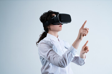 Woman controlling advanced virtual reality system using hand gestures while working with futuristic digital technology