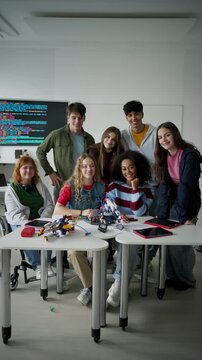 High school students working on robotics project. Girl in wheelchair among them.