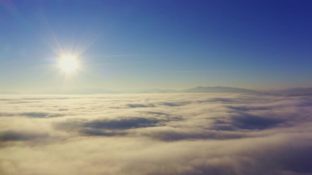 Wonderful view of extraordinary cloudy valley and bright orange sunset