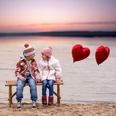 Romantic atmosphere by the lake with two cute children on a bench with red balloons.