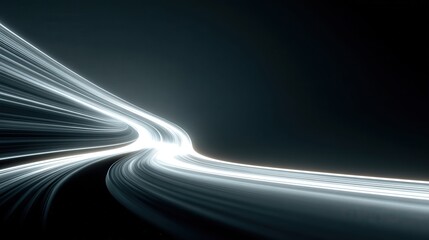 Lights move along a dark road creating bright trails and a sense of speed during nighttime with no visible cars or people