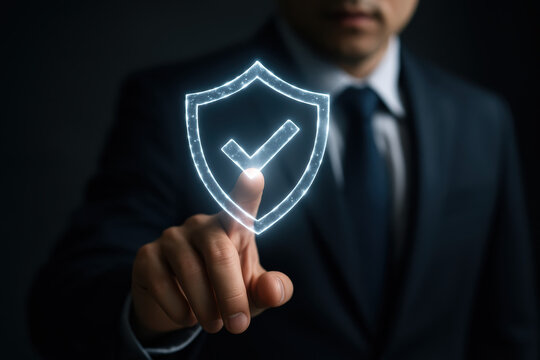 Security risk protection trust safety A business professional in suit touches glowing shield hologram to protect company assets and convey corporate compliance confidence